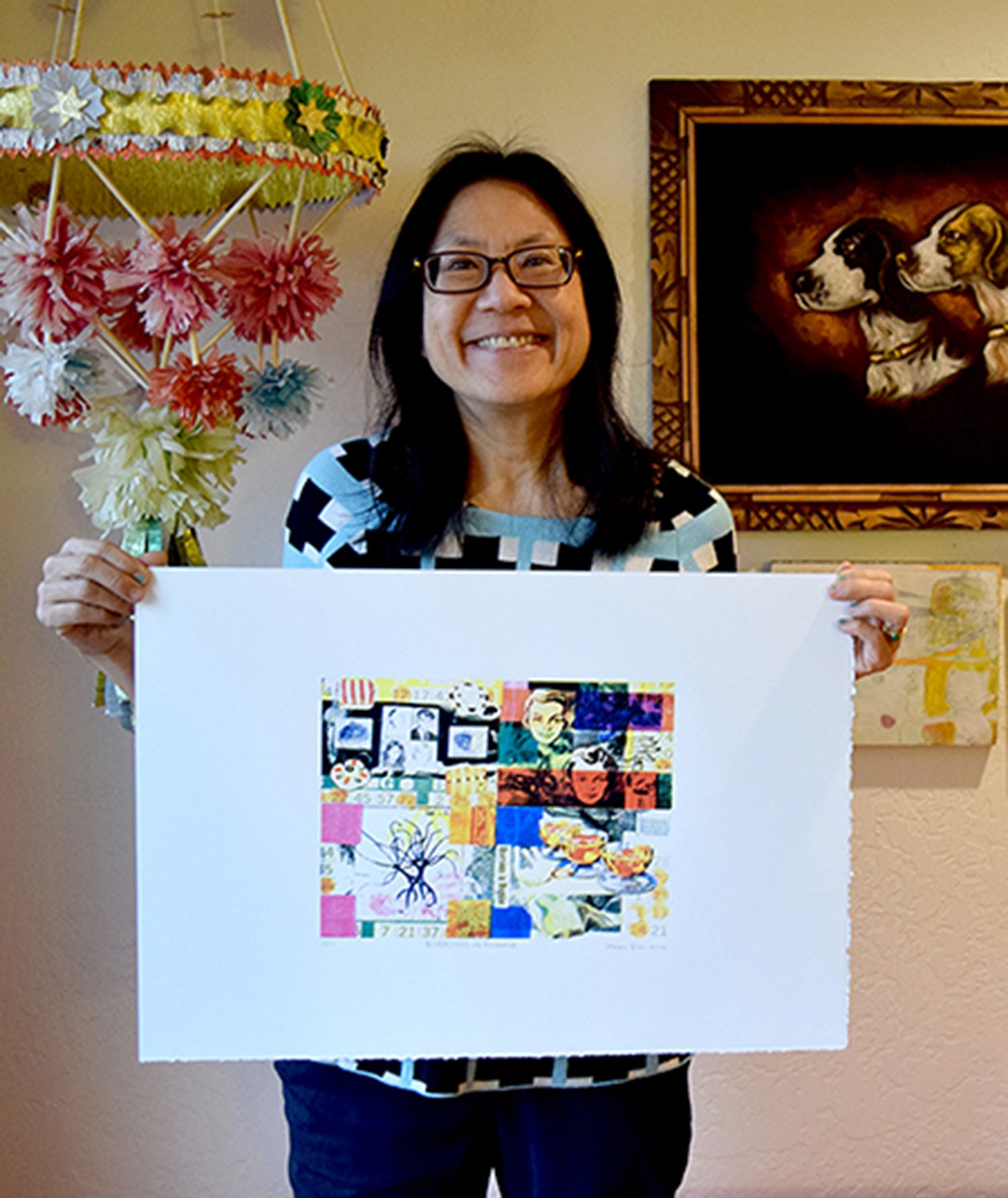 photo of Sharon Jue holding artwork