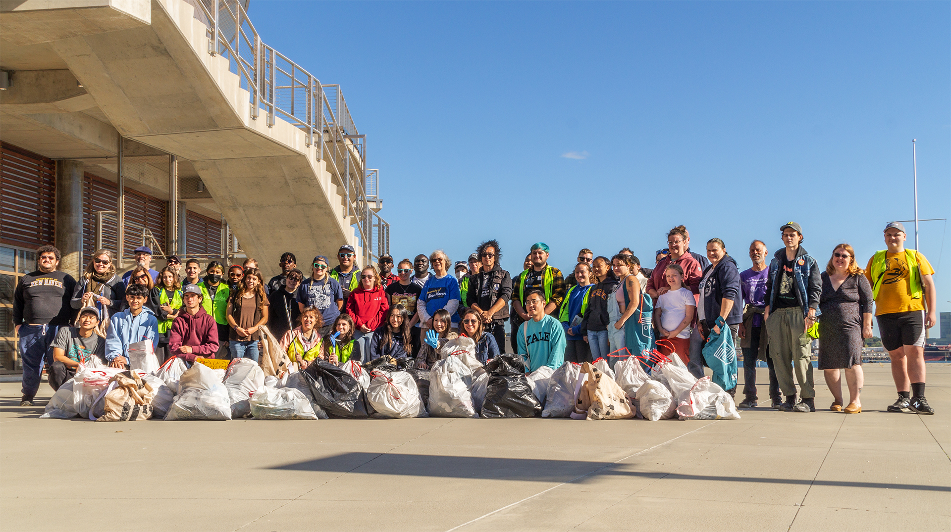 Photo of the artist with a group that helped clean up the Long Island Sound