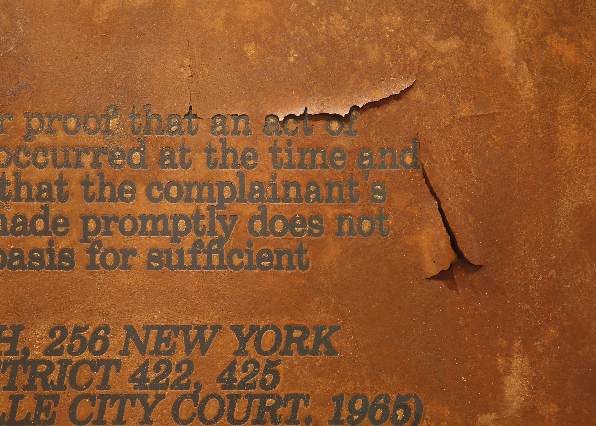 Detail of screenprint resist on steel with rust patina, text from 1965 New York District Court rape case ruling