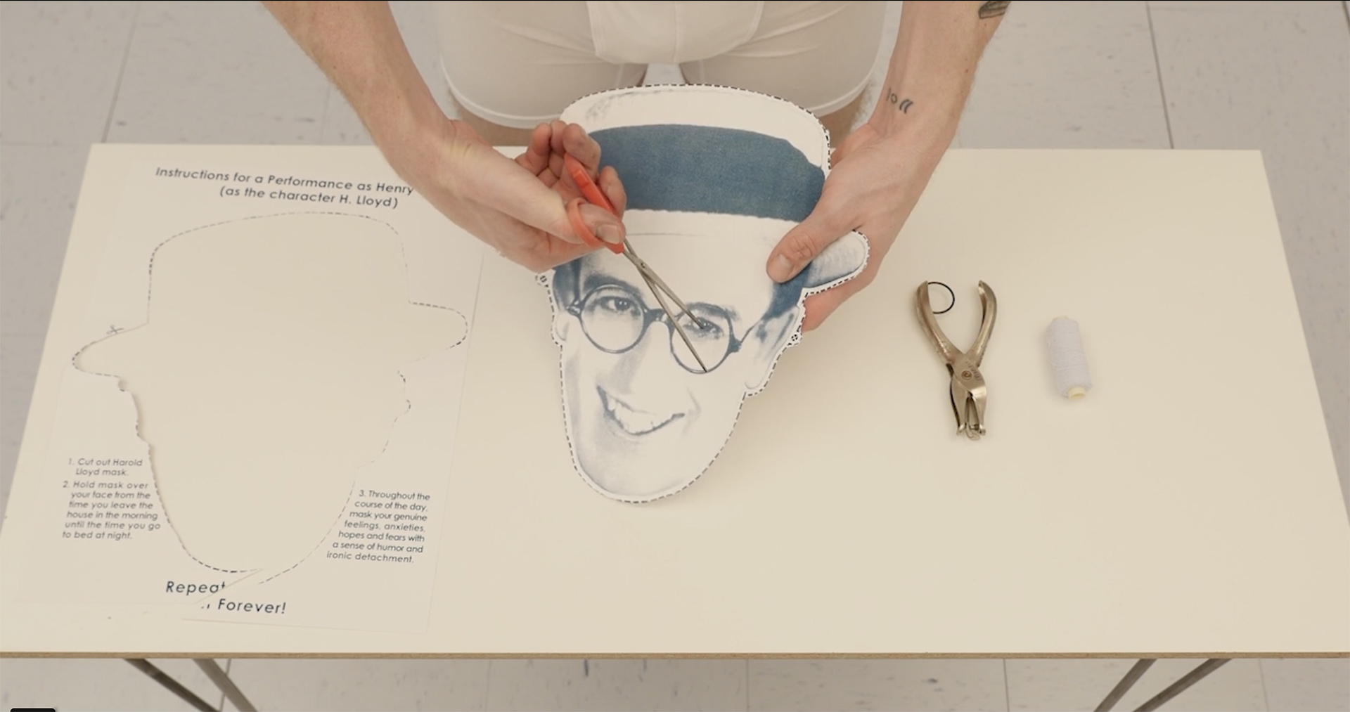 Screenprint of the silent film actor Harold Lloyd cut out by the artist as a performance