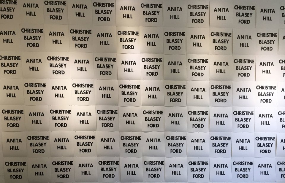 Lois Harada's Reverberations, featuring a wall of letterpress impressions alternating text with the names Anita Hill and Christine Blasey Ford, women who testified before congress about sexual assault and/or sexual harrassment by Supreme Court nominees.