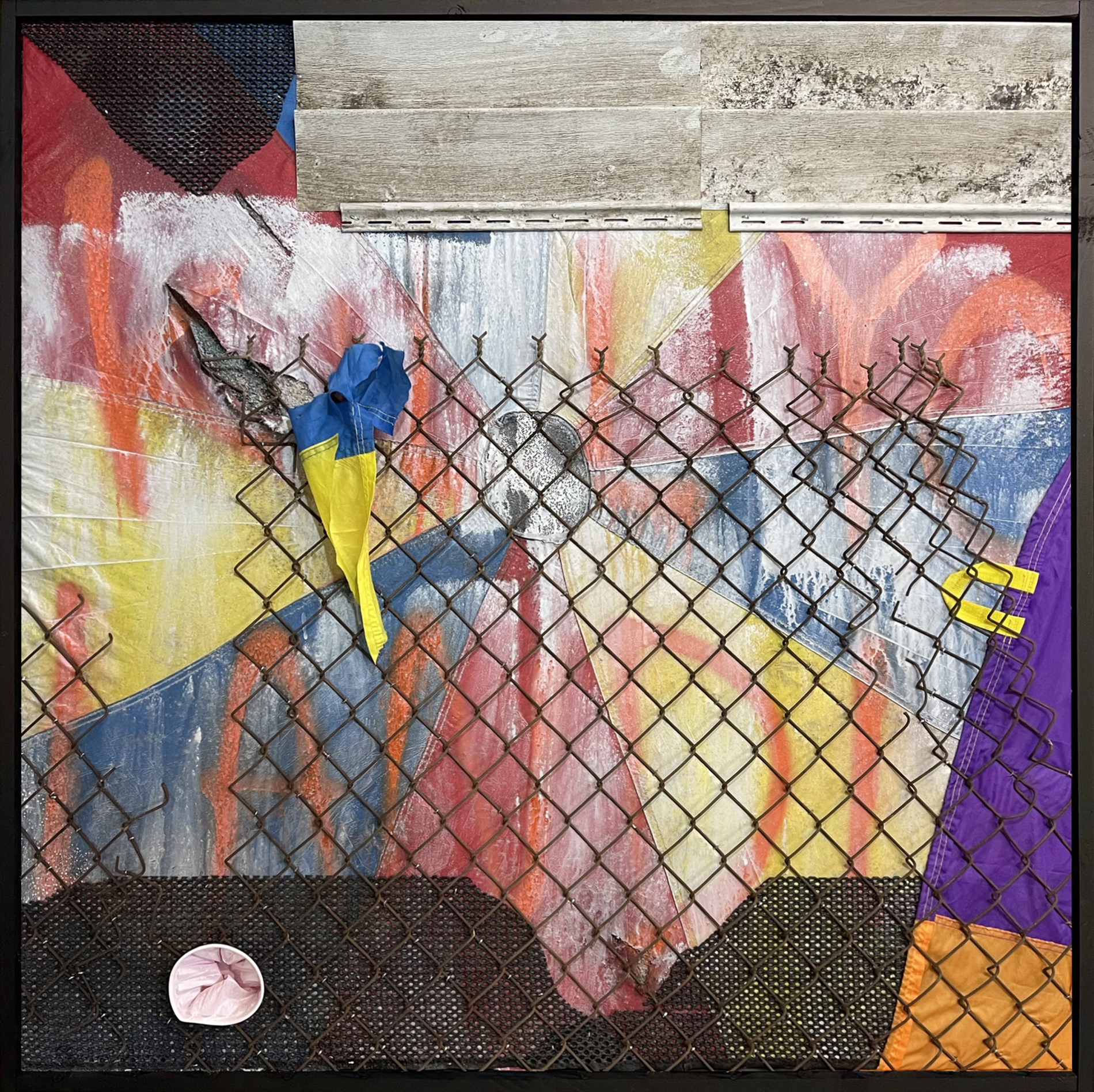 Kill Your Landlord, by Aaron Coleman. A mixed media assemblage made from commercial fencing, salvaged tarps and siding, and gym parachutes.