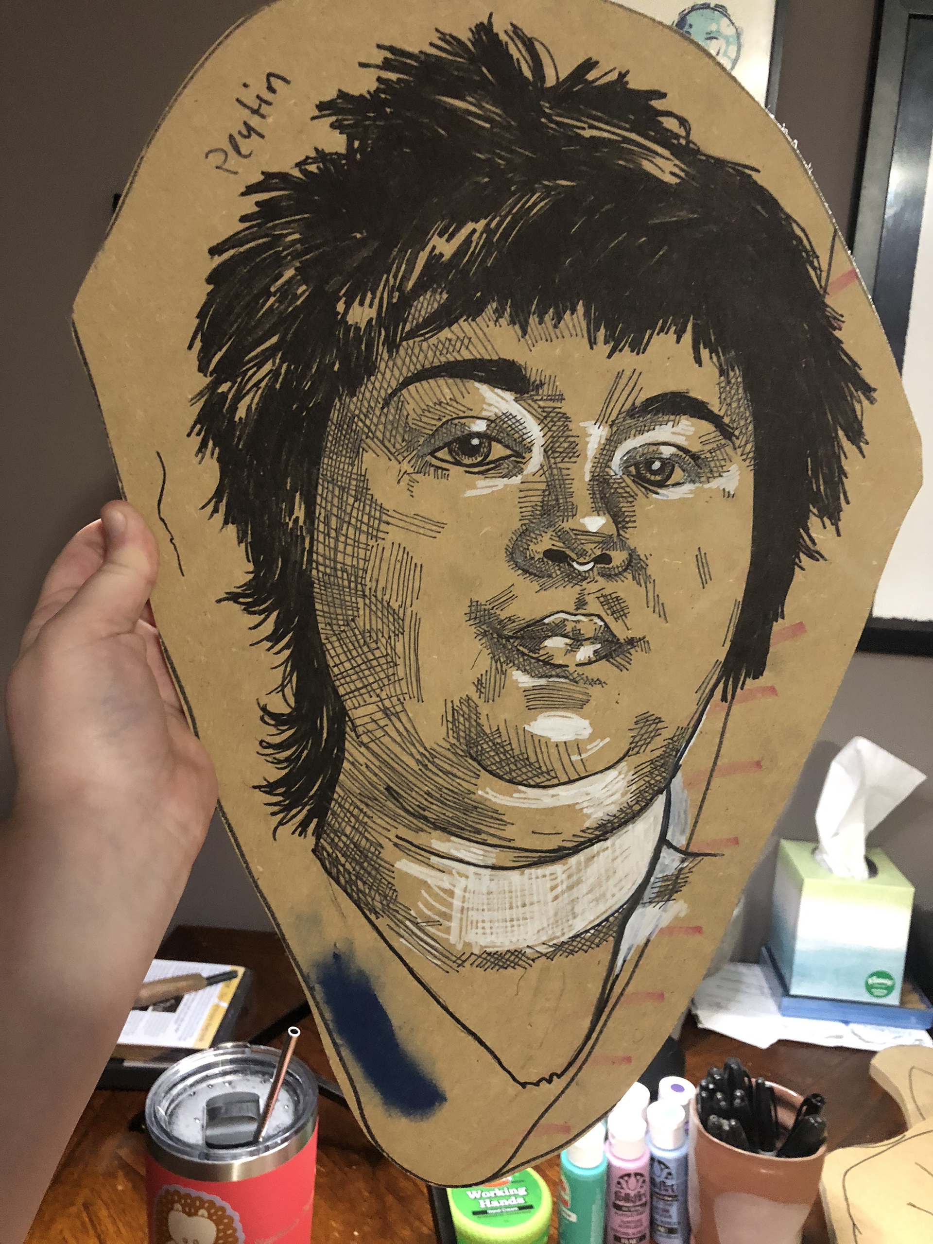 A ink and conte drawing of a portrait on MDF, ready to be carved.