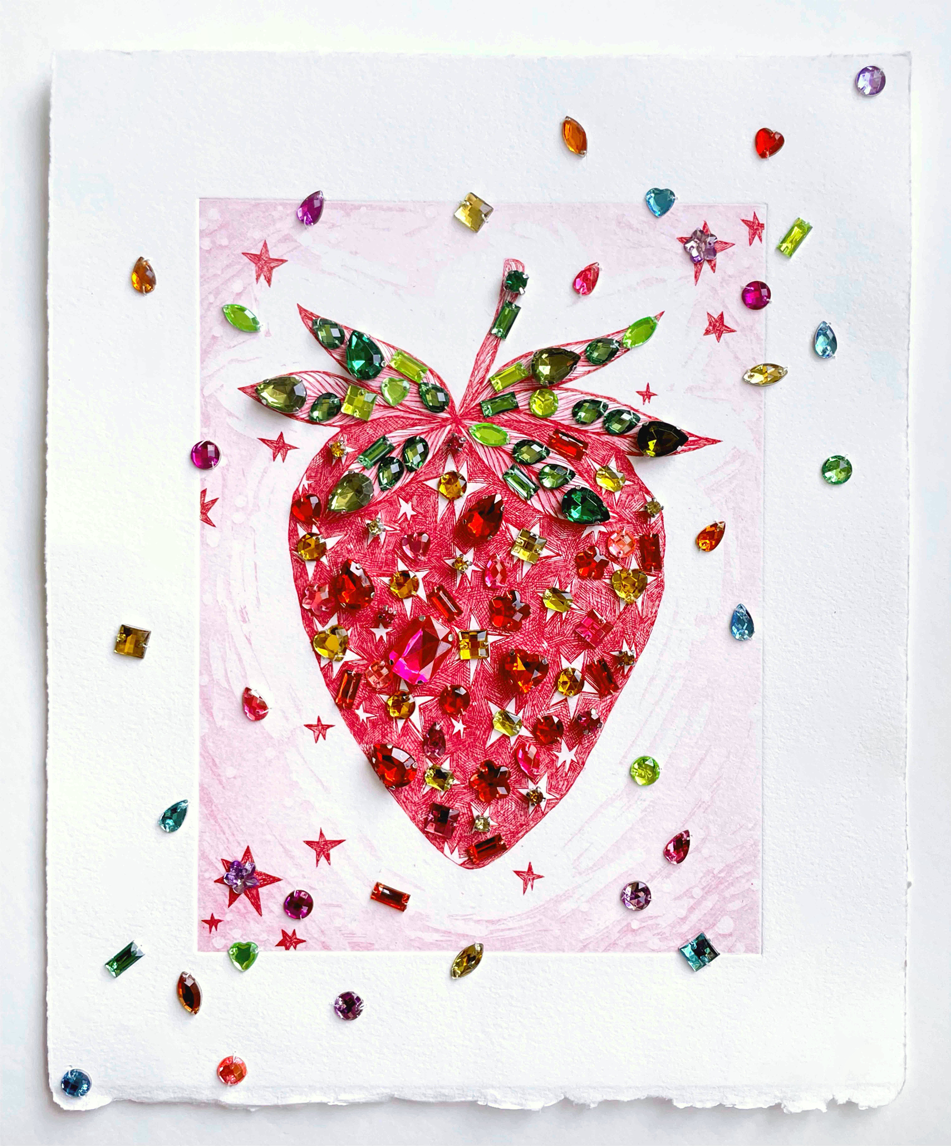 A red intaglio strawberry is covered with colorful plastic jewels.