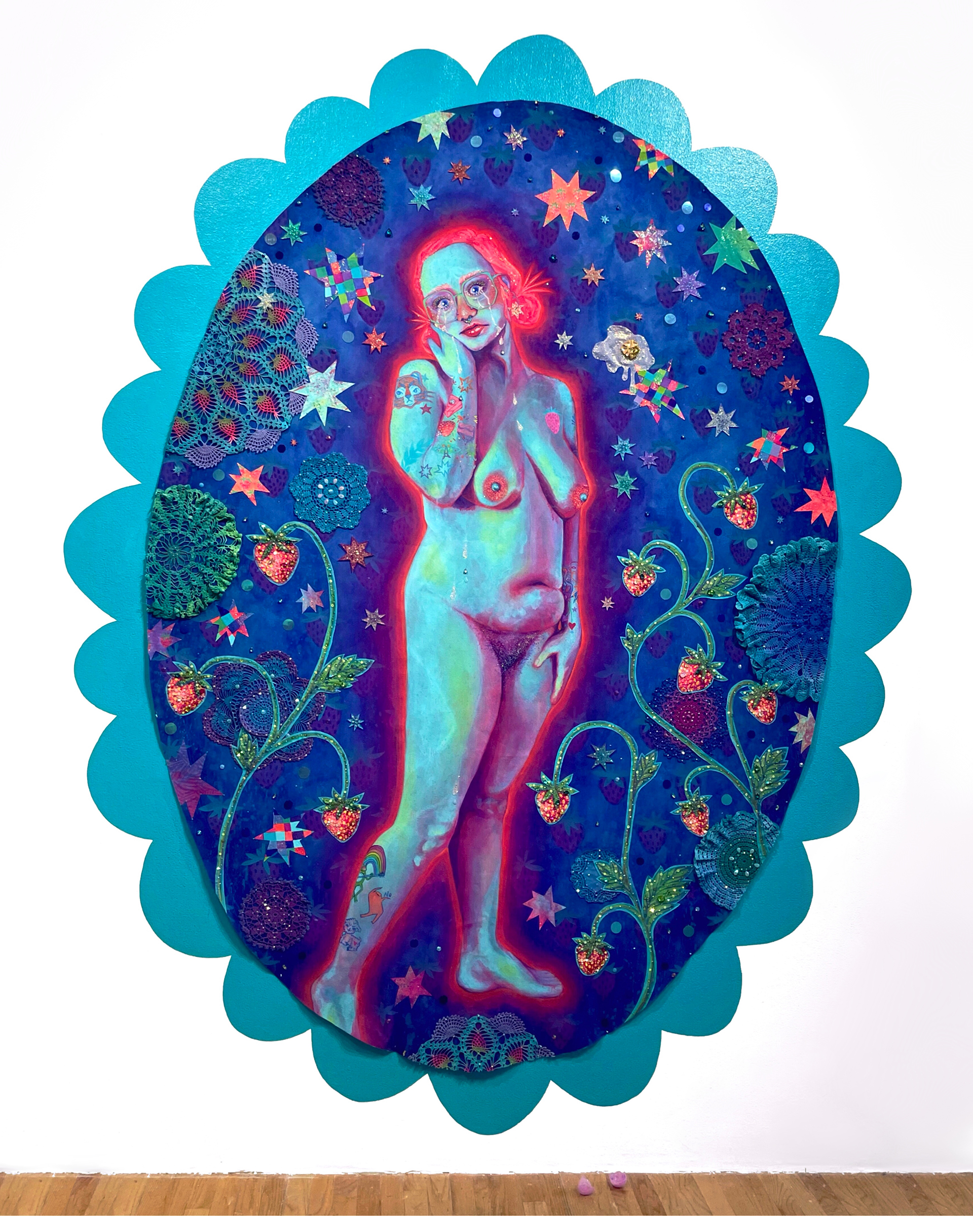 A human scale nude portrait is surrounded by an oval ground of intricate stars, doilies, and strawberries. The scene is framed by a teal scalloped frame.