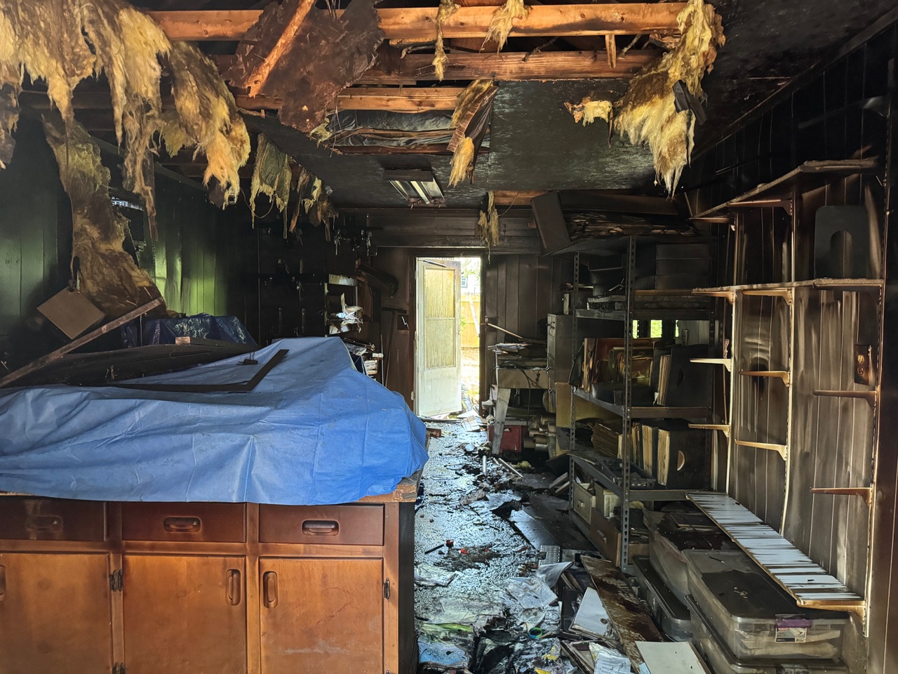 The charred, wet remains of Atabeira Press including sagging, burned drywall and insulation.