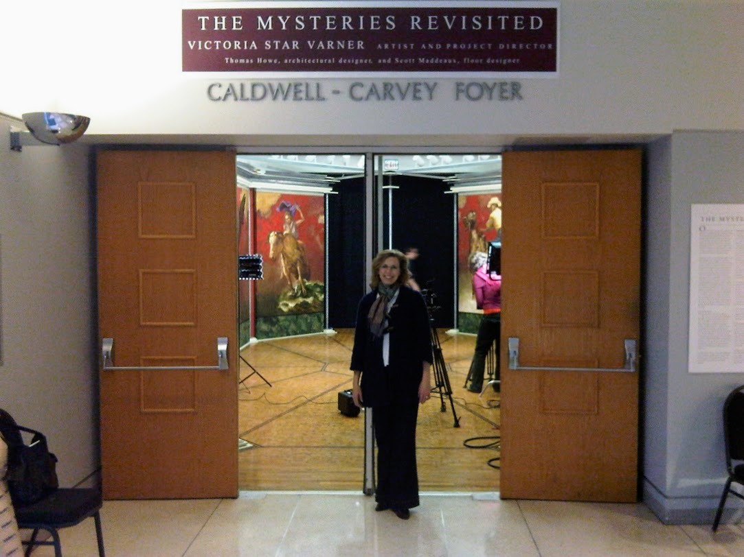 The artist stands outside the gallery for her exhibition The Mysteries Revisited