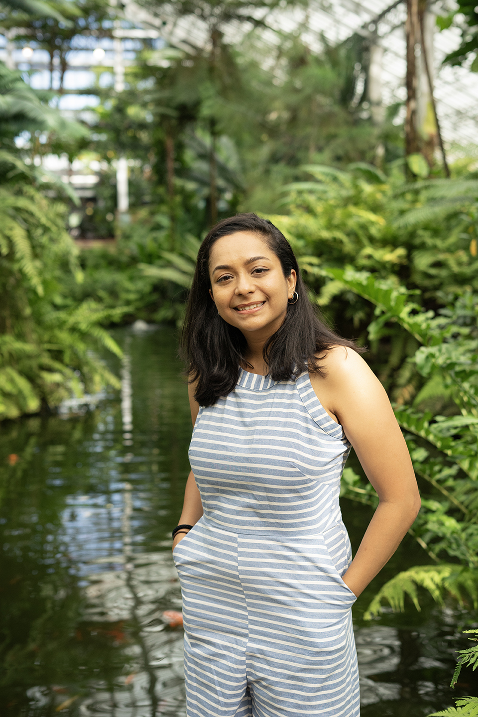 photo of the artist Janhavi Khemka in a lush enclosed botanical garden