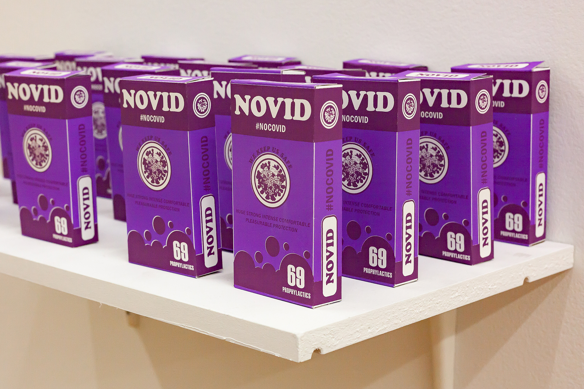 A staggered arrangement of purple boxes of "Novid" prophylactics promoting truly safe sex during the pandemic.