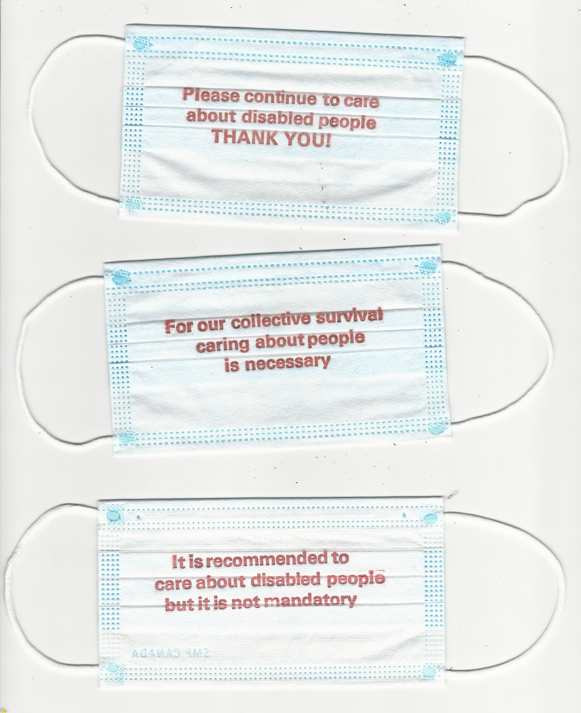 Paper surgical masks are printed in red text that encourages care and empathy for disabled people, in the context of but not exclusive to the COVID pandemic.