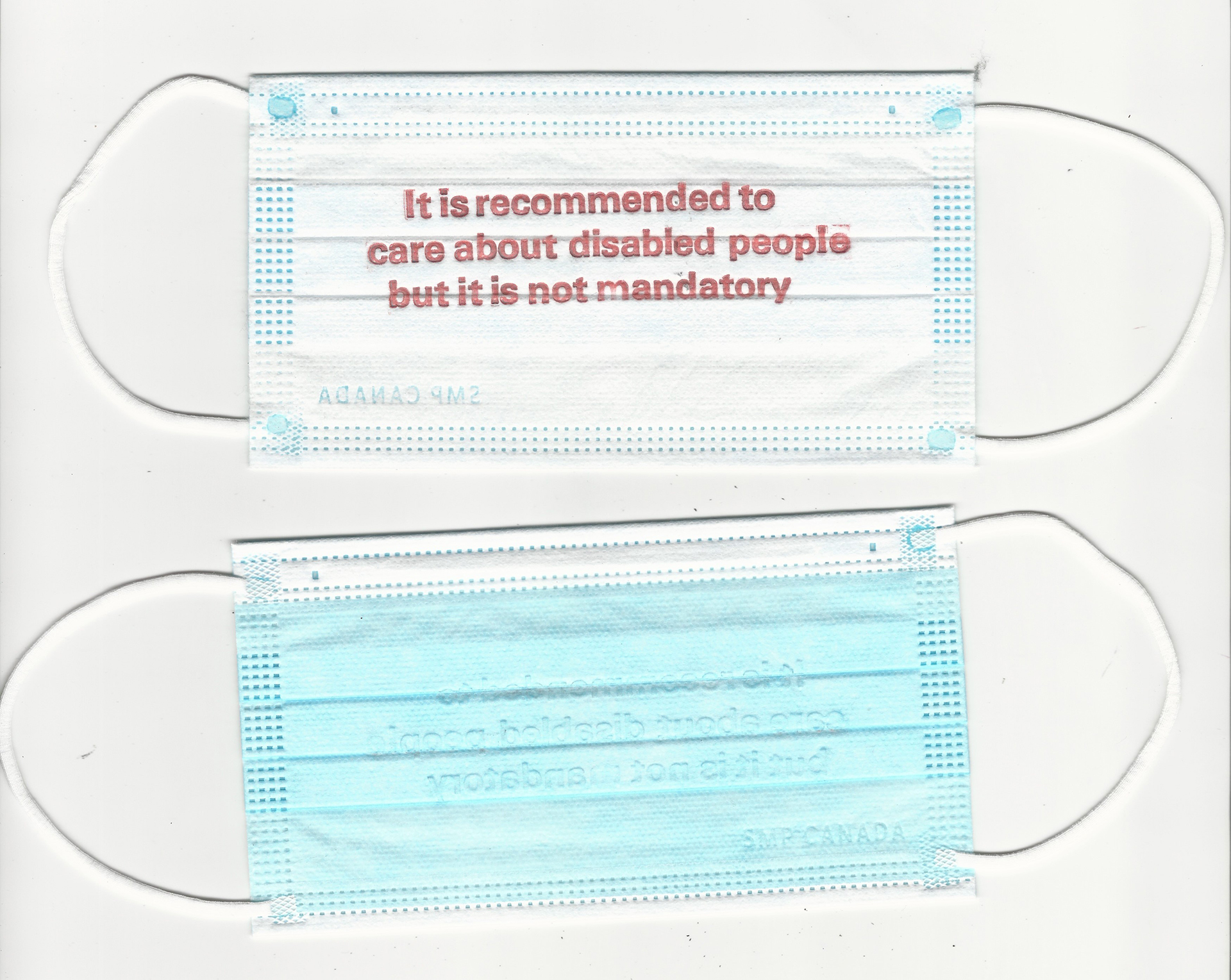 The front and back of surgical masks letterpress printed in red text that encourages care and empathy for disabled people, in the context of but not exclusive to the COVID pandemic.