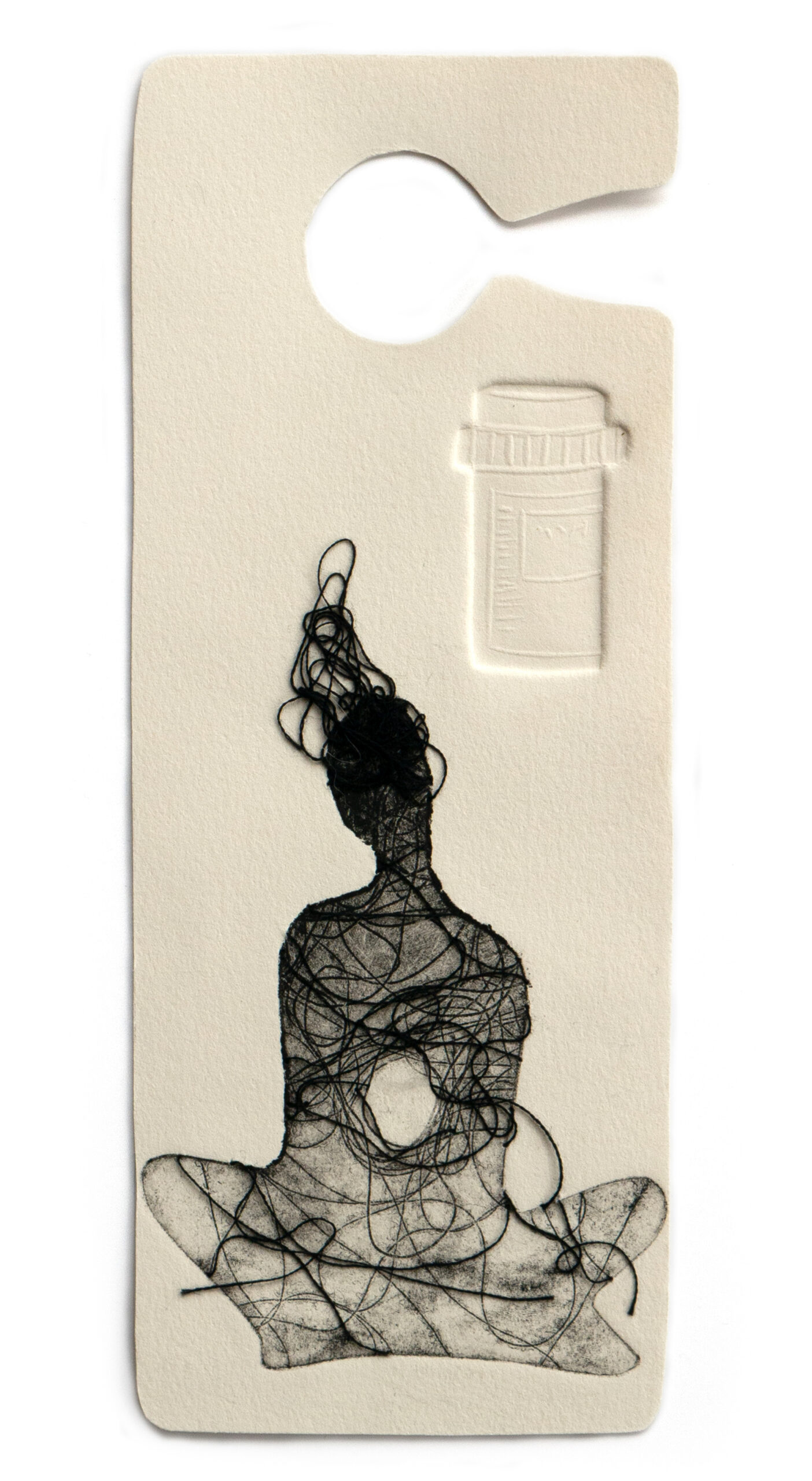 A print shaped like an accessible-parking placard featuring a black figure sitting cross-legged next to an embossed pill container with a mess of black threads over its face.