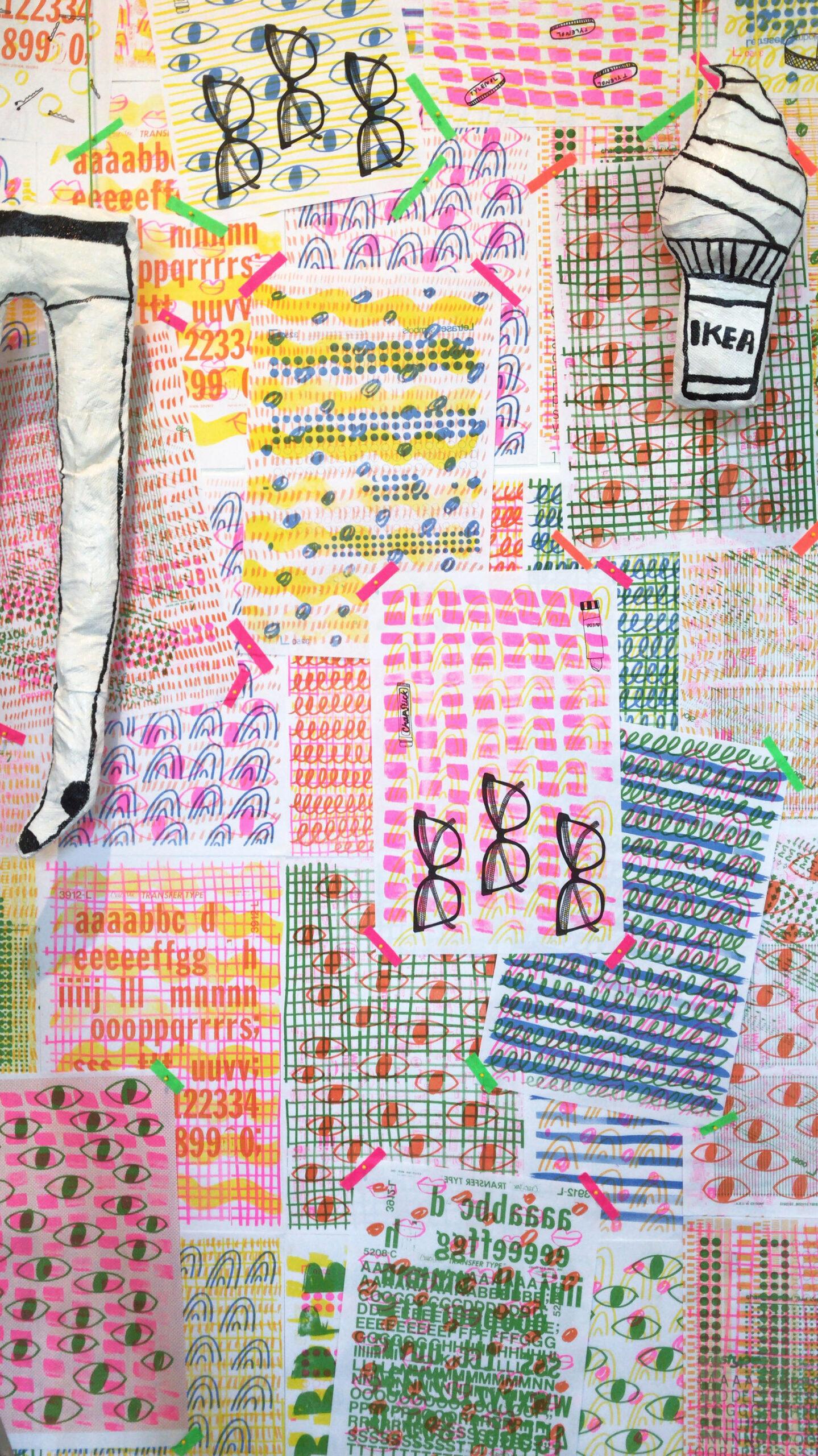 bingamanburt_kate_1 A pile of printed thin paper meant to mimic cough drop wrappers starts on a ledge and cascades onto the gallery floor. Text nearby encourages visitors to take one of the wrappers.