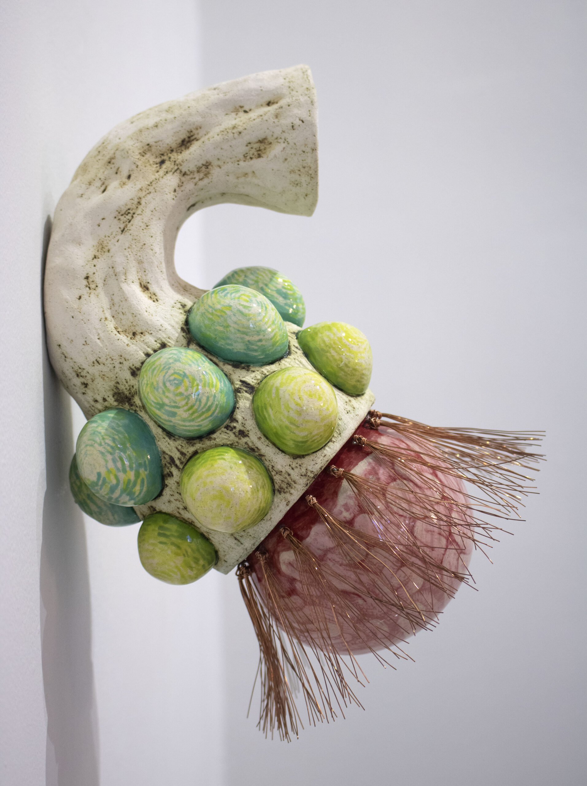 IMG_7319 An alien cornucopia looking fruit is composed of a ceramic base with screenprinted protuberances and copper wire that evokes dandelion fluff.