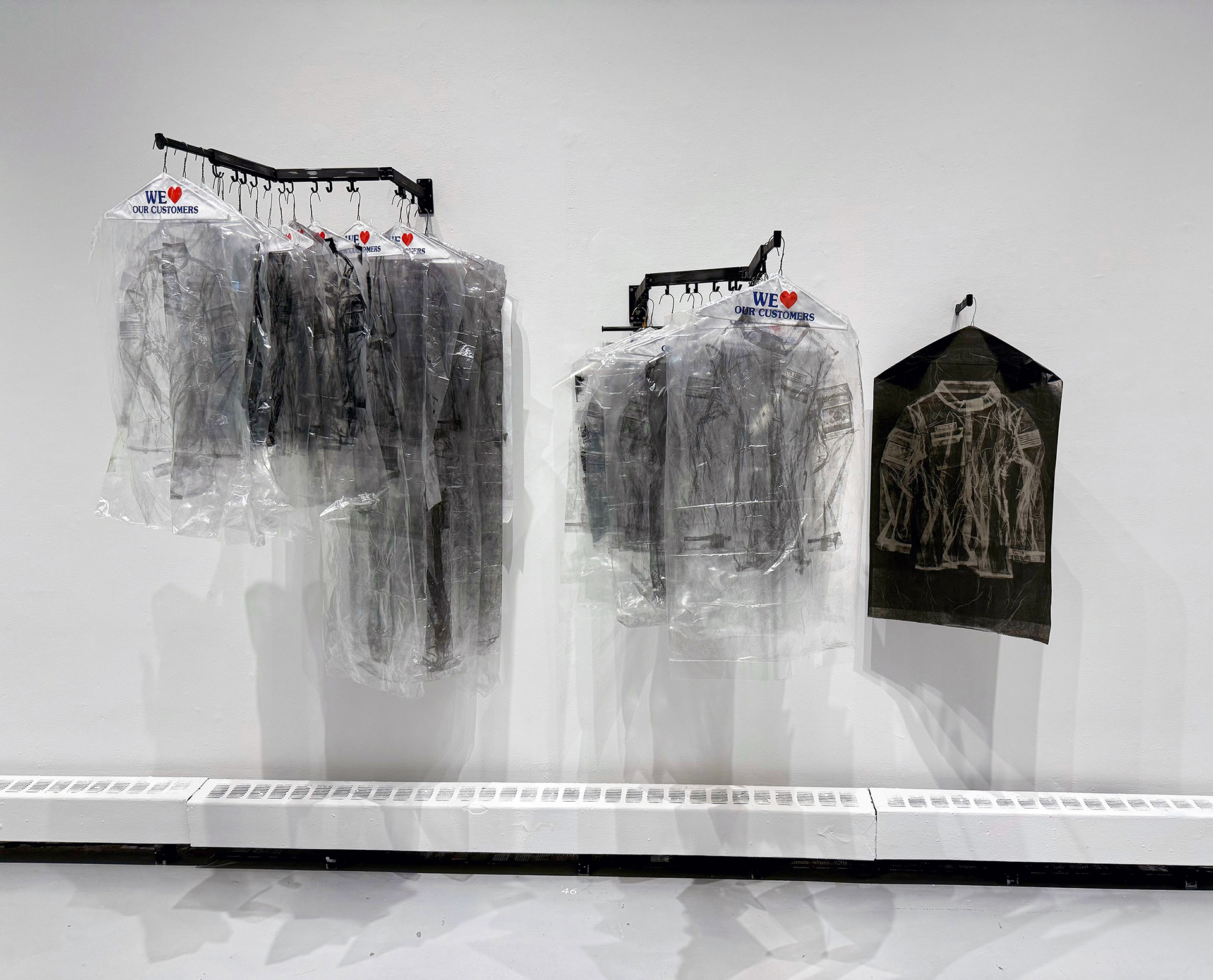 ImprintsofHeroes_SokSong_5 This sculptural installation uses layers of translucent dry-cleaning plastic imprinted with graphite to create ghostlike forms of uniforms, echoes of militarism, and the residual presence of memory. Referencing the artist’s childhood in a Korean-American dry-cleaning business, the piece intertwines personal history with broader questions of valor, sacrifice, and the overlooked labor behind symbolic cleanliness and national pride.