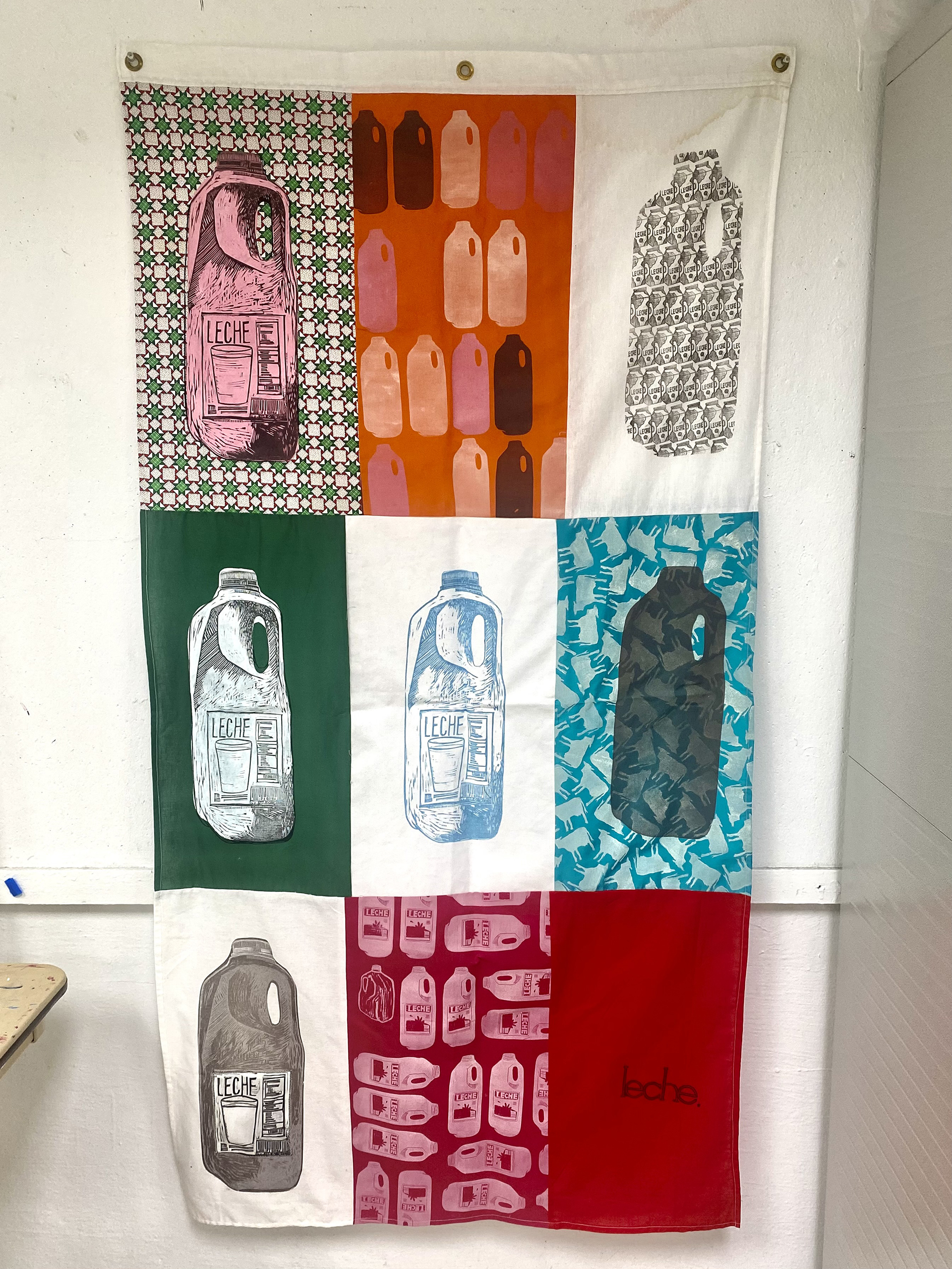 A grid of nine fabric compositions in various colors riff on gallons of milk