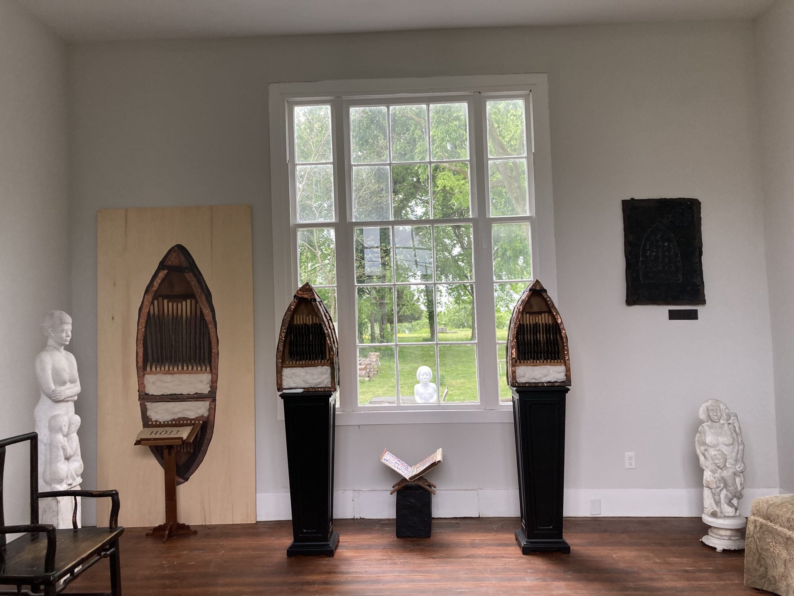 An accordion book, layered with wave motifs in cool colors. In each page an arched occlusion like a window is filled with text in some, and abstracted colographs in warm colors in others.