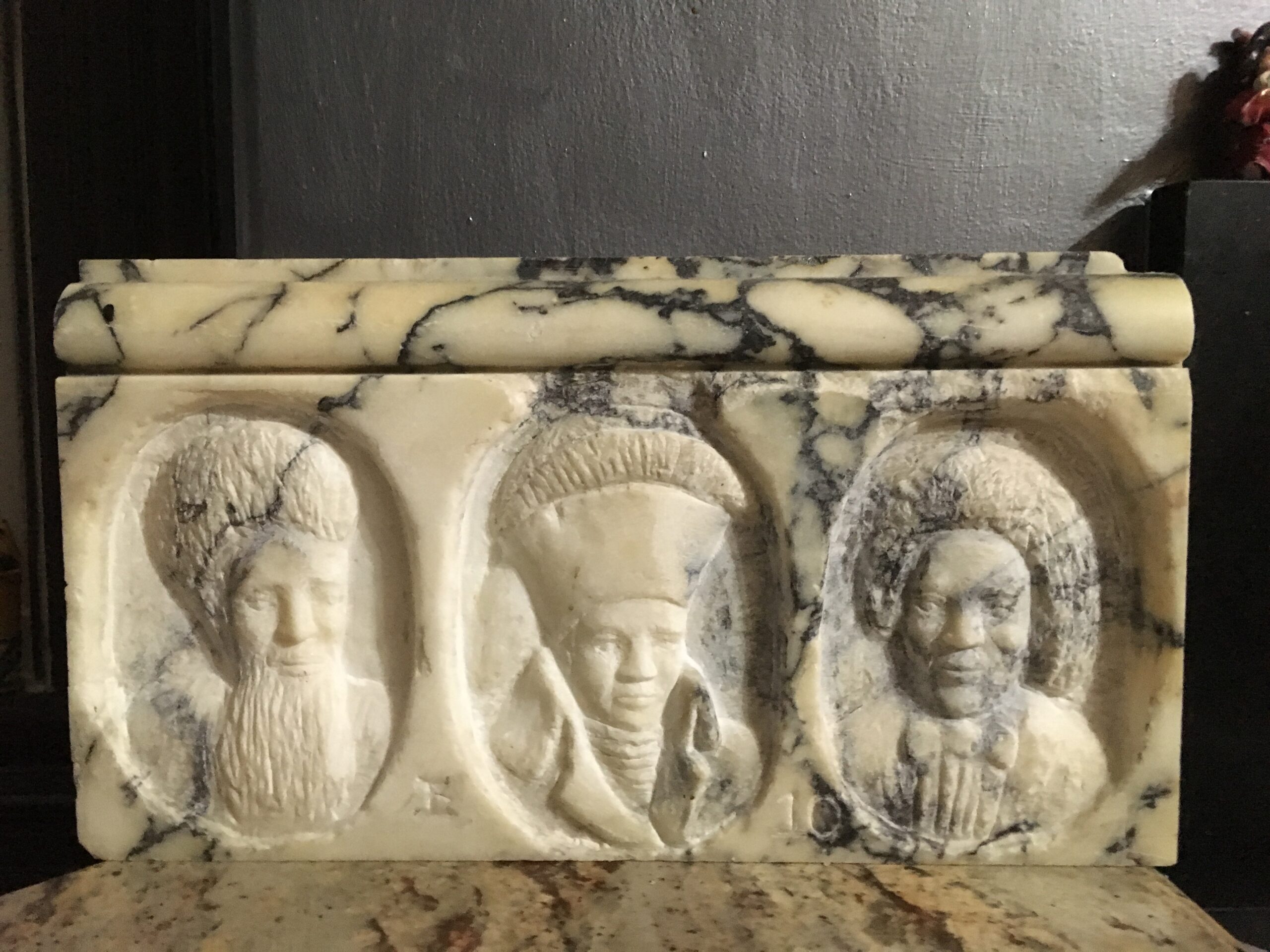 An accordion book with an abstracted collagraph seascape with a bright sunset and red arches in the background, and arched window popouts filled with figures in silhouette.