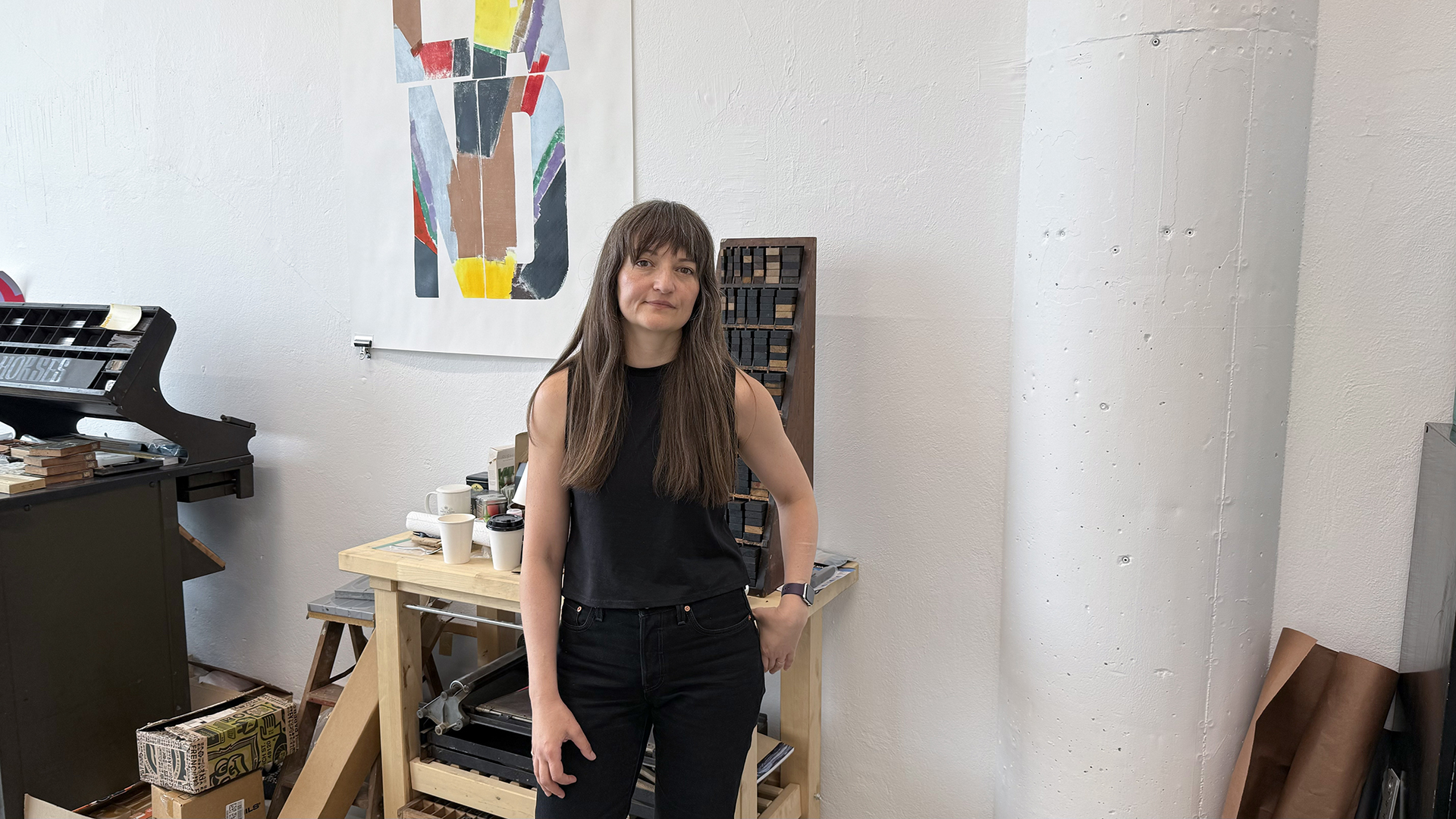 photo of artist, Jennifer Graves in front of her work