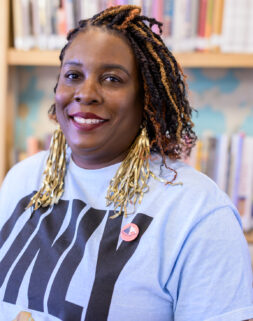 Photo of artist, Lauren Emeritz at a platen press