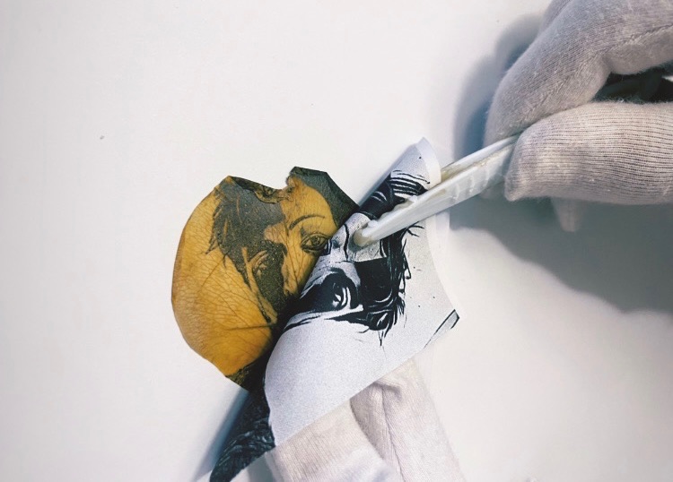 A femme presenting individual with a Bob haircut faces ¾ to the left. They are printed in pink and blue, overlapping to make purple. The two layers are comprised of pink tiny scribbles placed very closely in a grid formation. The person hands are grabbing at their chest and have a far off expression on their face.  A lime green square grid overlaps itself in the background and on top of the person, leaving part of their face and chest exposed. </p>
<p>The print has distorted squares cut out of the paper. There is a bright pink scribble behind the cut out section, and in the upper right corner.<br />
