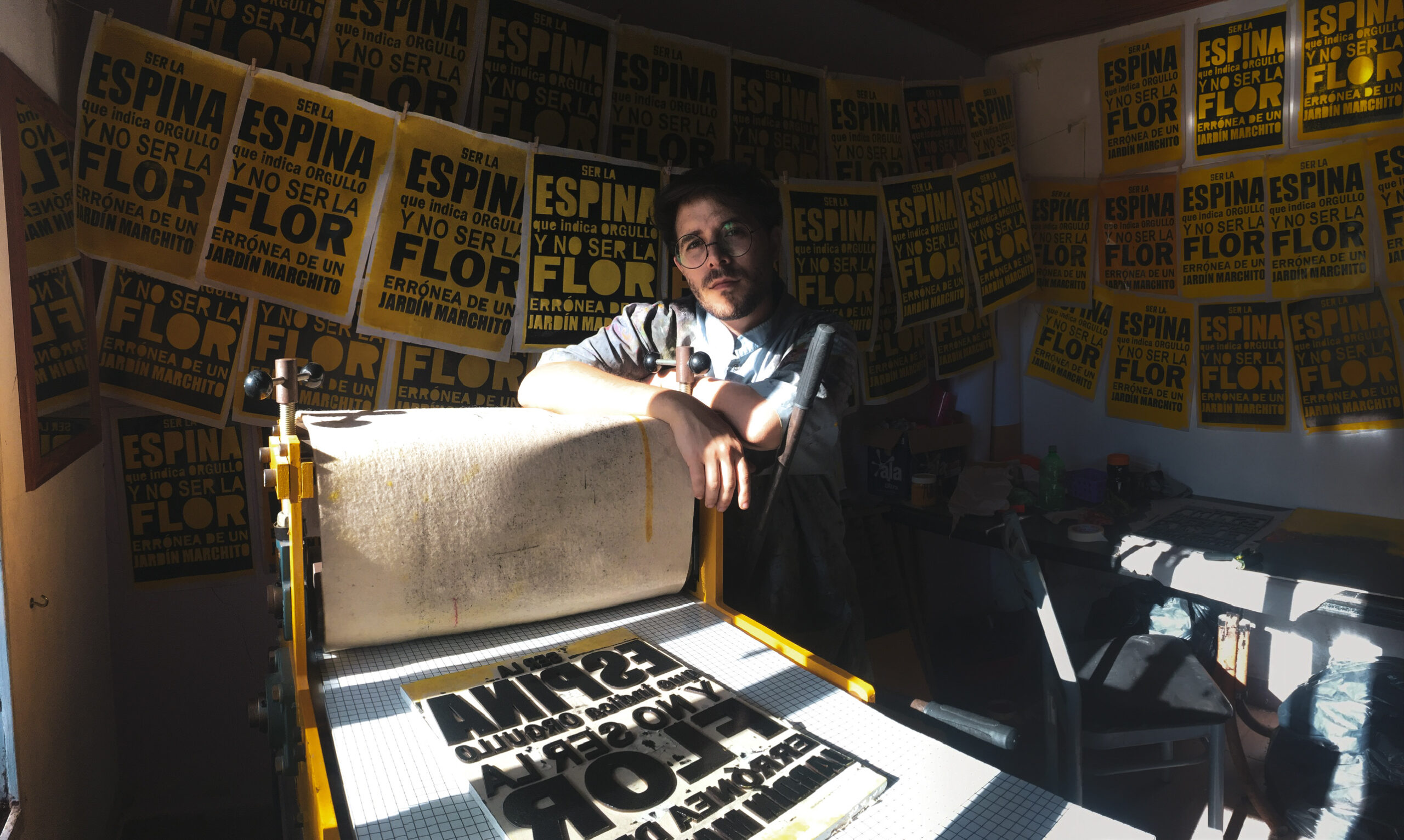 A fluorescent pink abstract shape sits atop a background grid pattern comprised of much smaller abstract scribbled marks in a light teal color.